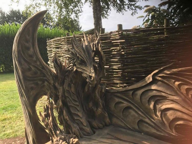 Chainsaw artist carves giant log into incredible dragon bench